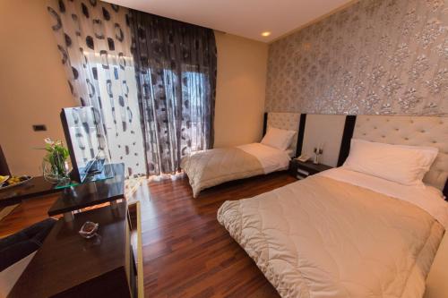 Postel nebo postele na pokoji v ubytování Hotel Brilant Saranda