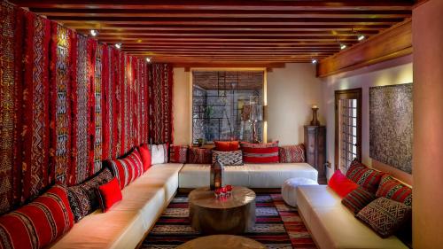 a living room with a long couch and a table at Karawan Riad in Fès