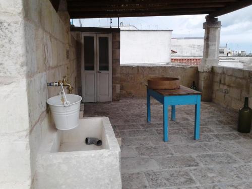 a bathroom with a tub and a table and a sink at Borgoincorte in Martano