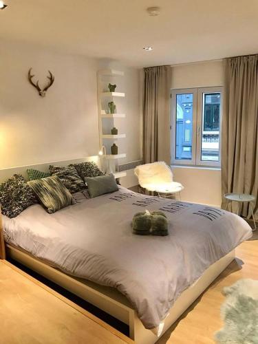 a bedroom with a large bed and a window at Your suite Ghent in Ghent