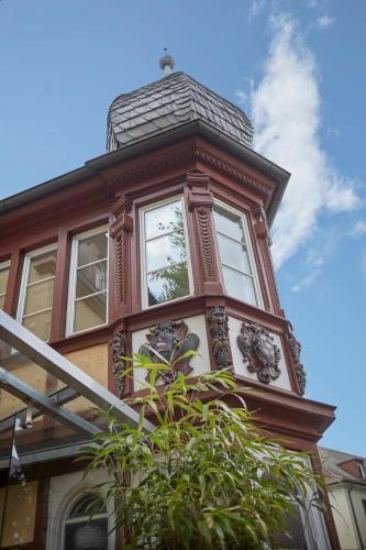 a building with a clock on the top of it at Badischer Hof in Bühl