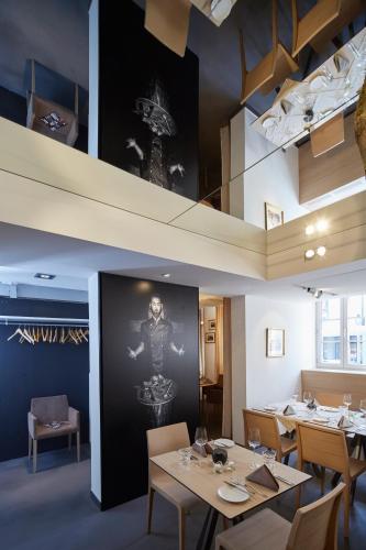 a dining room with tables and chairs and a wall at Badischer Hof in Bühl