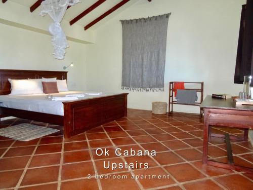 a bedroom with a bed and a desk in it at Ok Cabana Negombo in Negombo