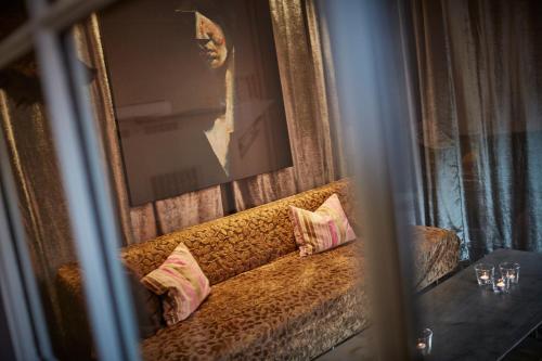 a reflection of a couch with two pillows on it at Badischer Hof in Bühl