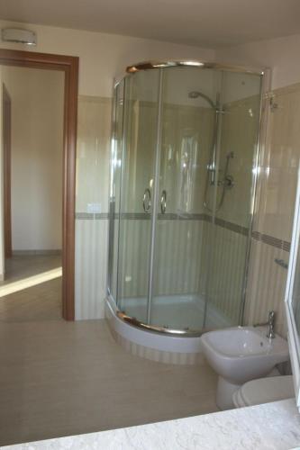 a bathroom with a shower and a toilet and a sink at B&B e Casa Vacanza al Castello in Roccella Ionica