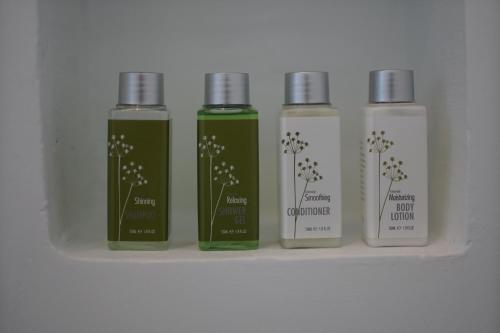 a group of four bottles sitting on a shelf at Aroma Angkor Boutique Hotel in Siem Reap
