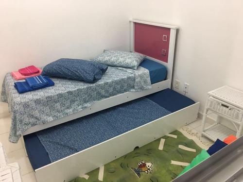 a bunk bed with two pillows on it in a room at Apto Praia Bertioga - 3 dormitorios sendo uma suite in Bertioga