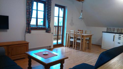 a living room with a couch and a table at Pension Polubný 922 in Kořenov