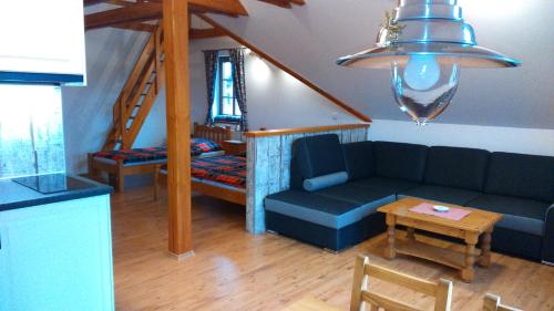 a living room with a couch and a table at Pension Polubný 922 in Kořenov