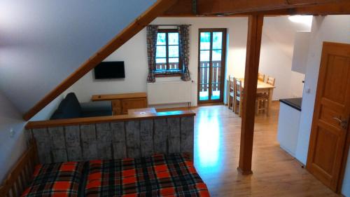 a room with a staircase and a living room at Pension Polubný 922 in Kořenov