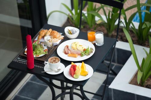 two plates of breakfast food on a table at Aroma Angkor Boutique Hotel in Siem Reap
