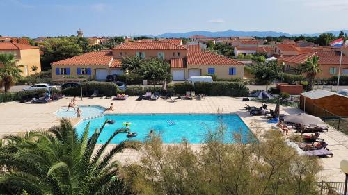 une vue d'une piscine dans un complexe hôtelier dans l'établissement Résidence La Pinède, au Barcarès