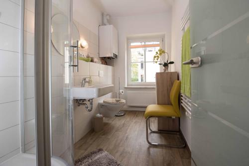 a bathroom with a sink and a toilet and a window at Sonnenhof Plauen in Plauen