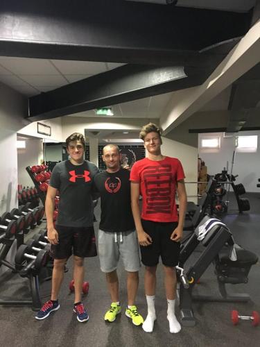 three men standing in a gym posing for a picture at Hotel Luna in Žiar nad Hronom