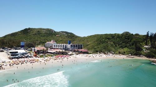 a group of people on a beach in the water at Cris Hotel in Florianópolis