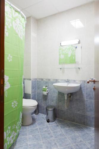 a bathroom with a toilet and a sink at Family Hotel Gorski Kut in Rilski Manastir