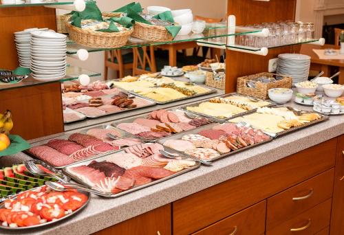 a buffet with many different types of food on display at Hotel Stadt Waren in Waren