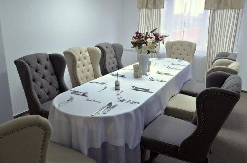 a table with a white table cloth on it at Hotel Luna in Žiar nad Hronom