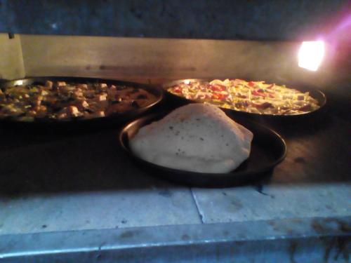 two pizzas are sitting in an oven at Penzion Pomodoro in Vrbno pod Pradědem