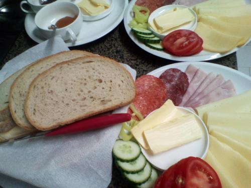 two plates with different types of cheeses and bread at Penzion Pomodoro in Vrbno pod Pradědem