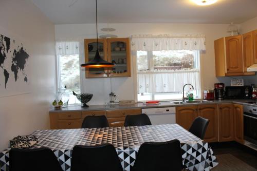 a kitchen with a table and chairs in it at Kriukot in Hólmavík