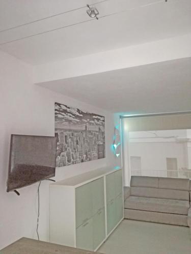a living room with a flat screen tv and a couch at bianco relax in Malo