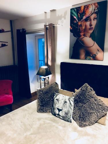 a bedroom with a lion pillow on a bed at Le Domaine du Chêne Vert in Château-Gontier