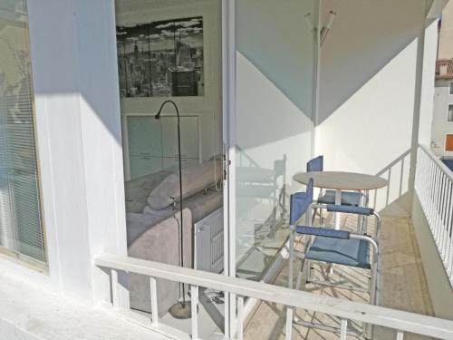 a balcony with a bed and a table and chairs at bianco relax in Malo