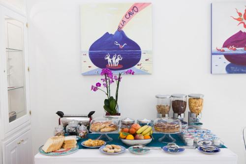 a table with a buffet of food on it at Isa Guest Rooms in Naples
