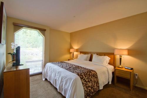 a bedroom with a large bed and a window at Ironwood 302 in Whistler