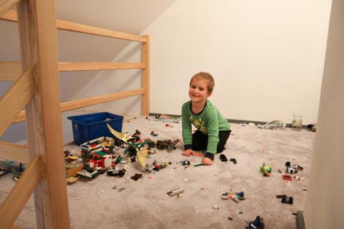 a young boy sitting on the floor playing with legos at Apartmán Fydorka in Jeseník