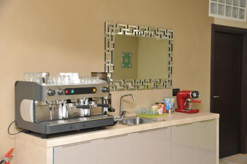 a kitchen with a coffee machine on a counter at Beverello Suite in Naples