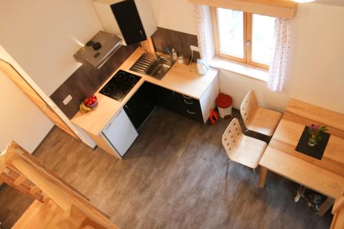 an overhead view of a kitchen with a stove and a table at Apartmán Fydorka in Jeseník