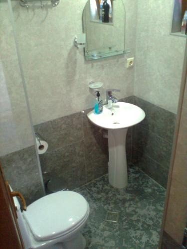 y baño con lavabo, aseo y espejo. en Vita, en Tiflis