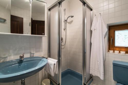 a bathroom with a blue sink and a shower at Am Eschenbichl in Mayrhofen