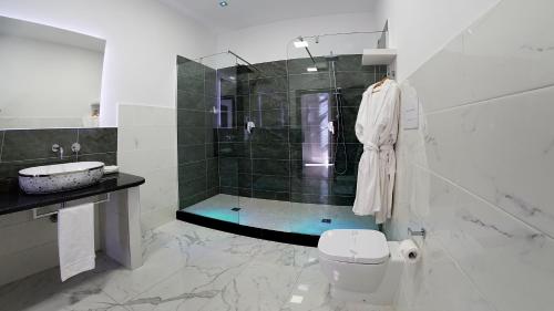 a bathroom with a shower and a toilet and a sink at Beverello Suite in Naples