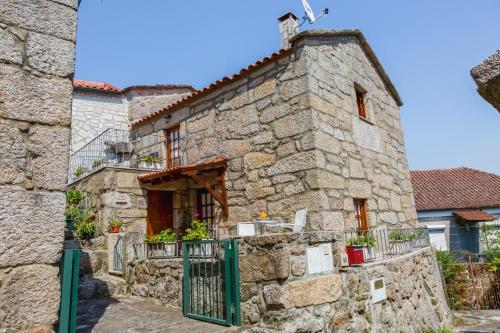 an old stone building with a cross on top of it at Casa Rautau in Soajo