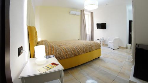 a bedroom with a bed and a table and a tv at Beverello Suite in Naples