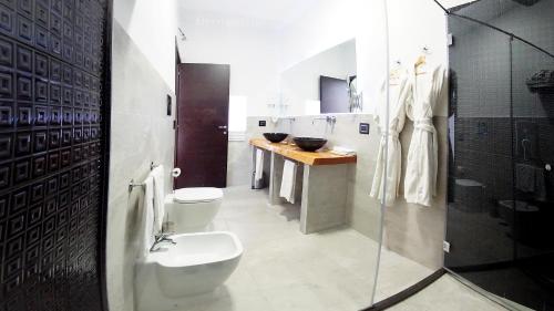 a bathroom with a toilet and a sink and a shower at Beverello Suite in Naples