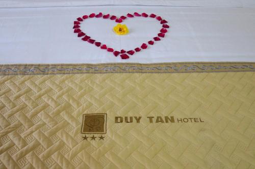 a heart on the wall with a sign that reads dry tram hotel at Duy Tan Hotel in Hue