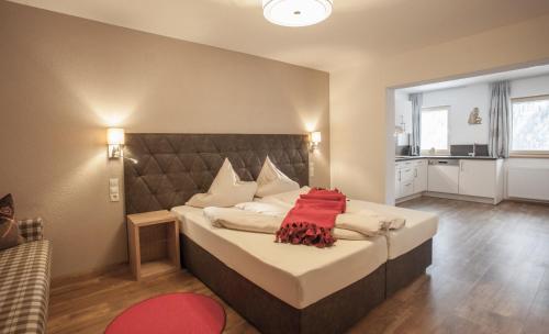 a bedroom with a large bed with a large headboard at Apart Hotel Arno in Sölden