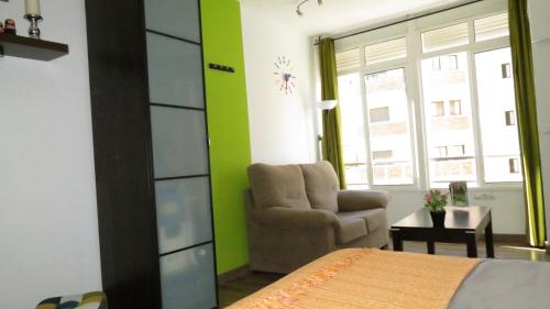 1 dormitorio con 1 cama, 1 silla y 1 ventana en Apartamento Rulosol 1, en Torremolinos