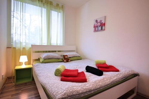 a bedroom with a bed with red pillows on it at Near Castle ☆ free bikes ☆ terrace in Prague