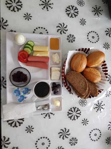 einen Tisch mit einem Tablett mit Käsebrot und anderen Lebensmitteln in der Unterkunft Apartment North City Hannover in Hannover