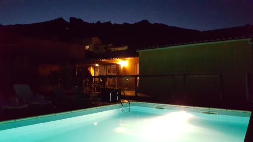 a swimming pool at night on a rooftop at Etape Cathare in Duilhac