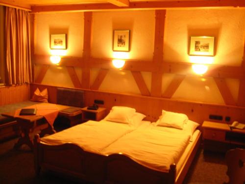 グライナウにあるGasthaus am Zierwaldのベッドルーム1室(ベッド2台、テーブル2台、照明付)
