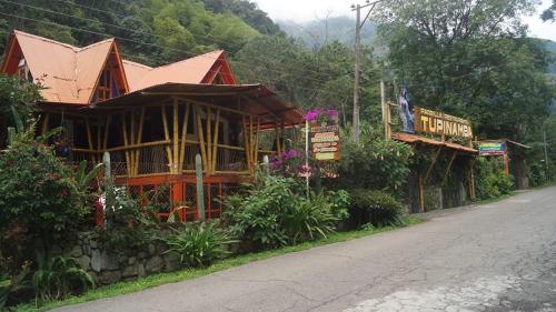 a building on the side of a road next to a street at Hospedaje Rural Tupinamba in Ibagué