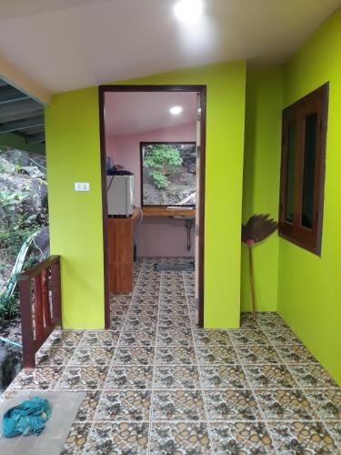 a room with green and pink walls and a desk at Easy Life Bungalows in Haad Yao