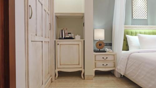 a bedroom with a bed and a nightstand next to a bed sidx sidx sidx at Sense Canggu Beach Hotel in Canggu