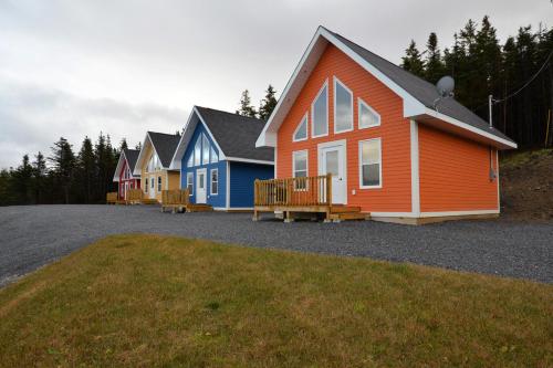 a row of colorful homes parked in a driveway at Bambury's Hillside Chalets in Rocky Harbour